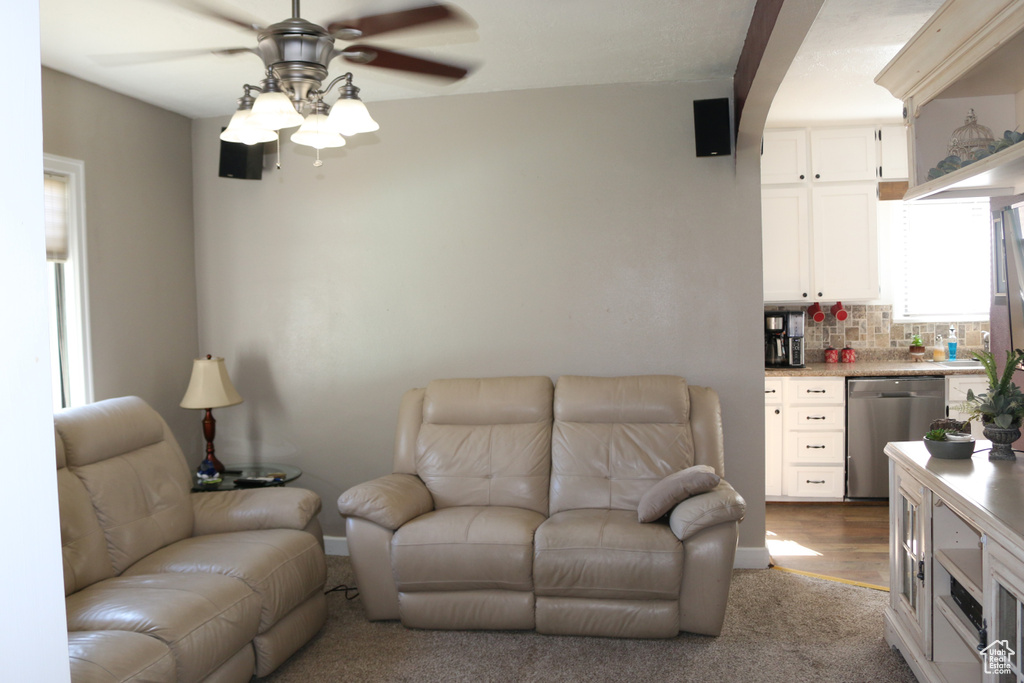 Living room with light wood-type flooring and ceiling fan