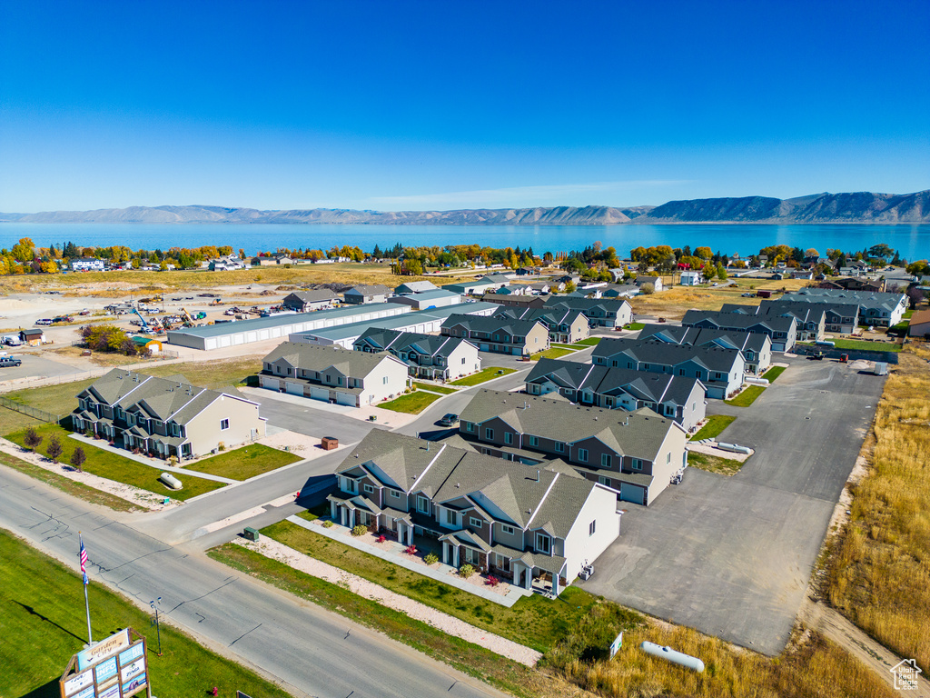 Birds eye view of property with a water and mountain view