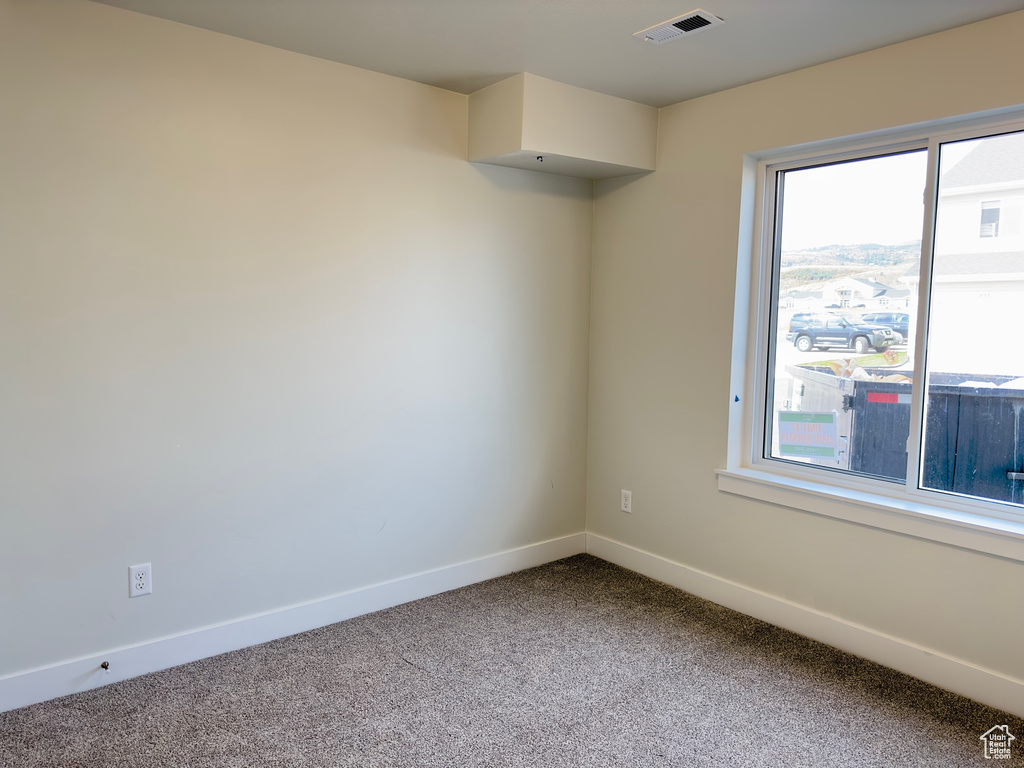 Empty room featuring light carpet