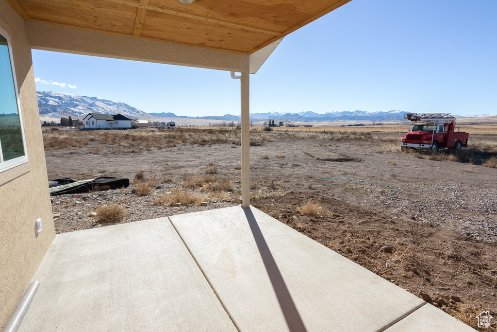 Exterior space featuring a rural view, a patio, and a mountain view