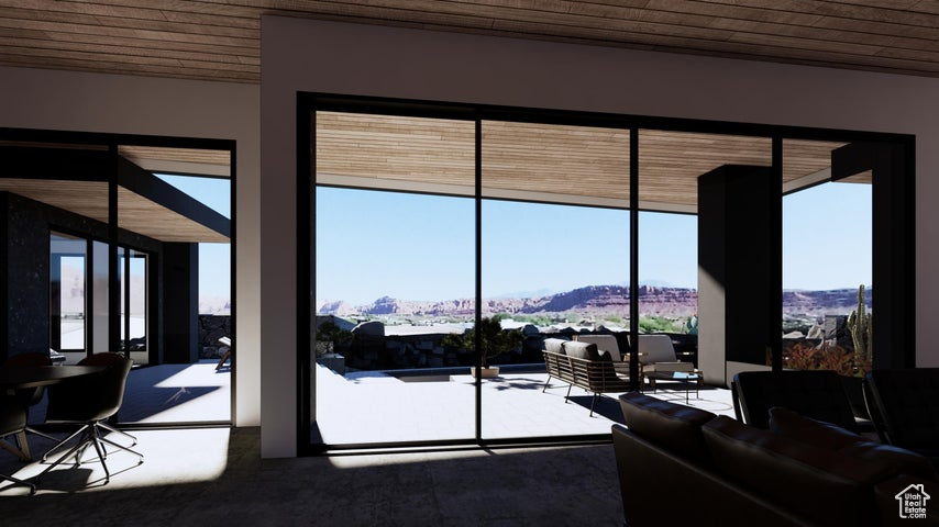 Living room featuring a mountain view, plenty of natural light, and carpet flooring
