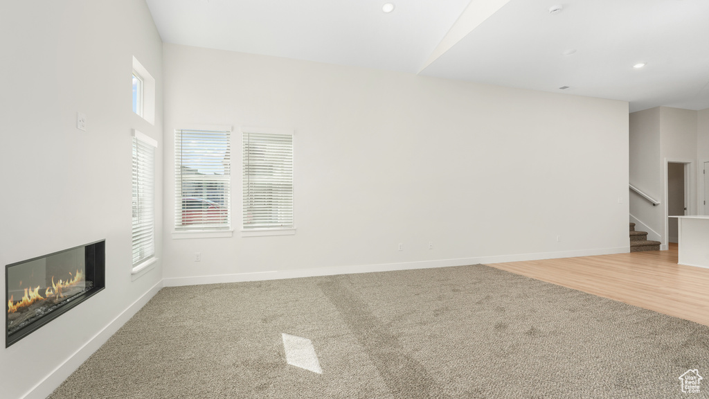 Unfurnished living room with plenty of natural light and light hardwood / wood-style floors