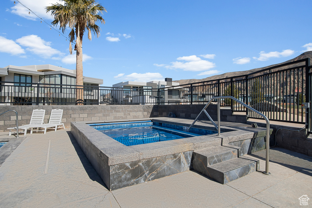 View of pool featuring a patio area and a hot tub