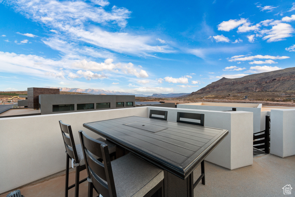 View of patio featuring a mountain view and a balcony