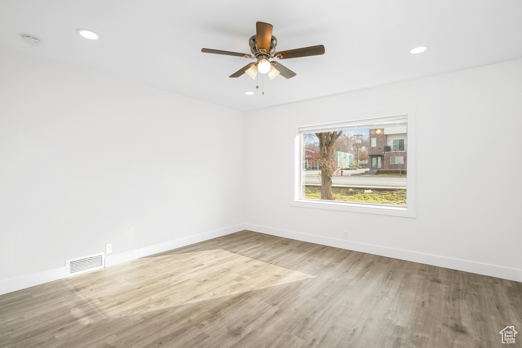 Empty room featuring light hardwood / wood-style flooring and ceiling fan