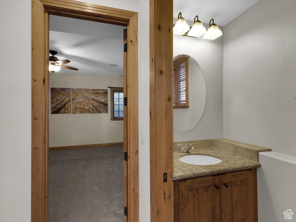 Bathroom with ceiling fan and vanity