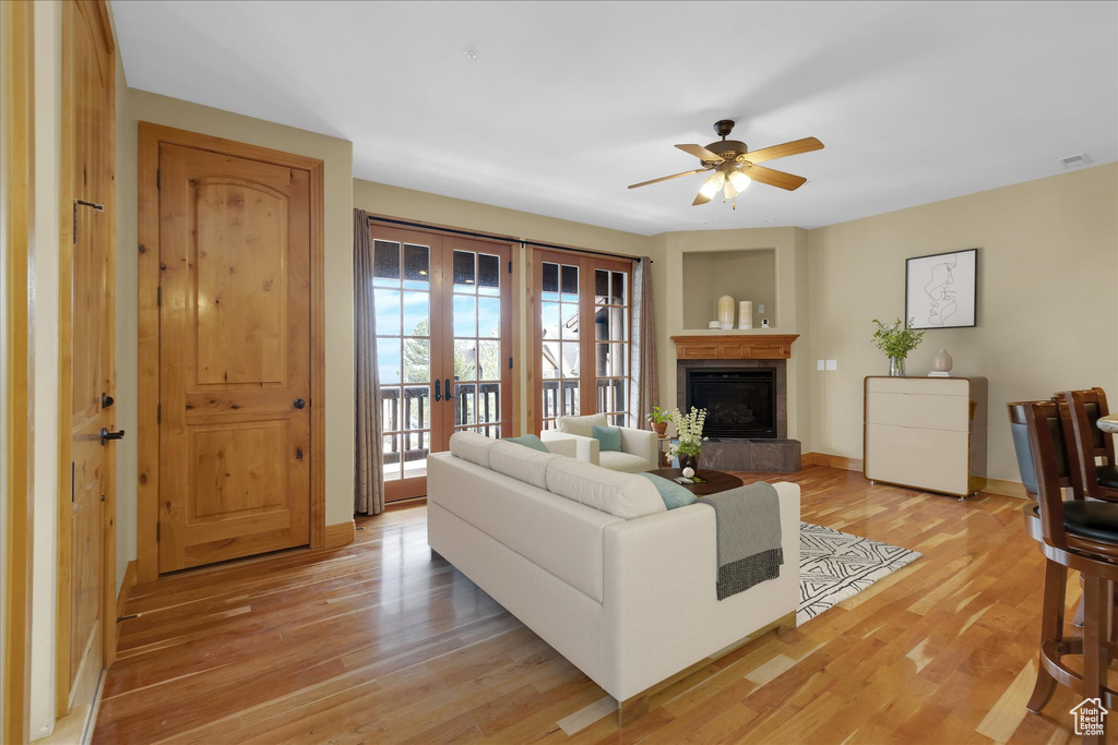 Living room featuring light hardwood / wood-style floors, ceiling fan, and french doors
