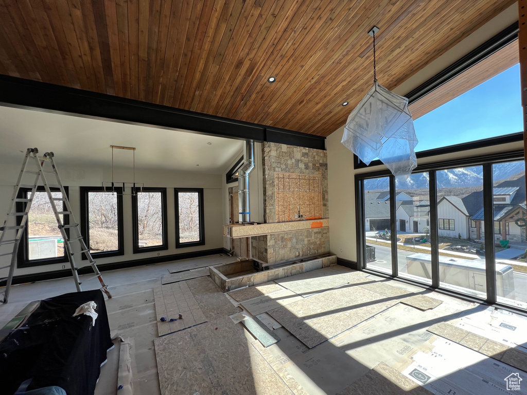 Unfurnished sunroom with lofted ceiling and wood ceiling