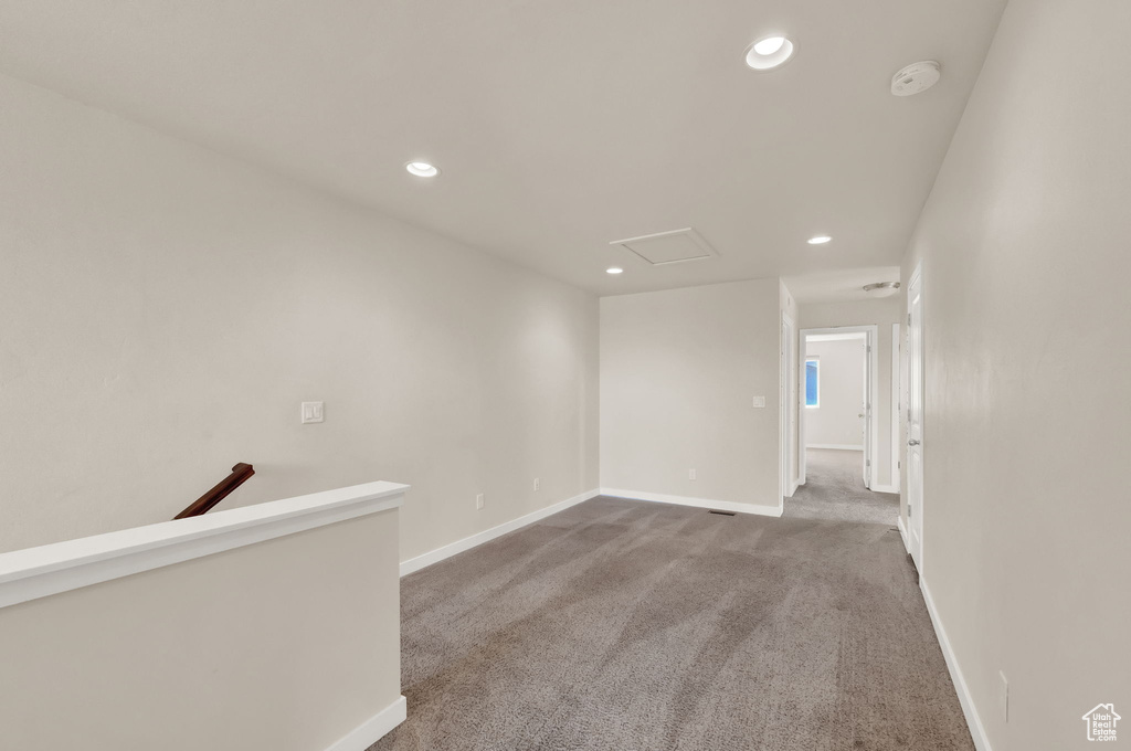 Unfurnished room with dark colored carpet