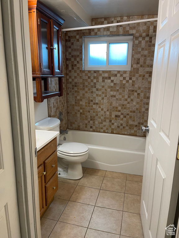 Full bathroom featuring vanity, tile flooring, toilet, and tiled shower / bath combo