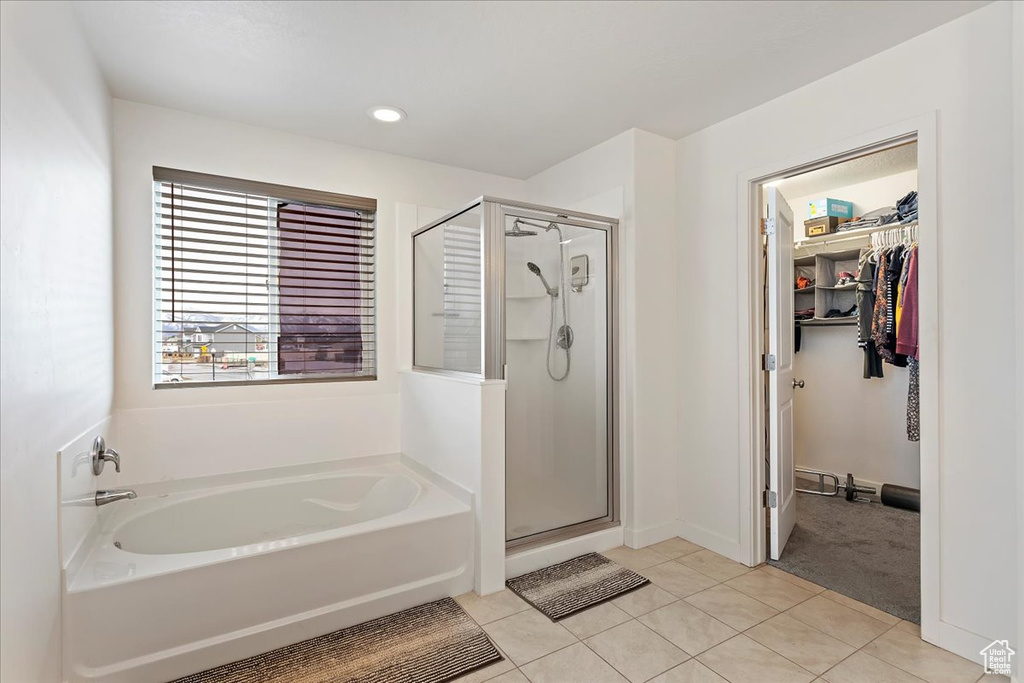 Bathroom with tile flooring and separate shower and tub