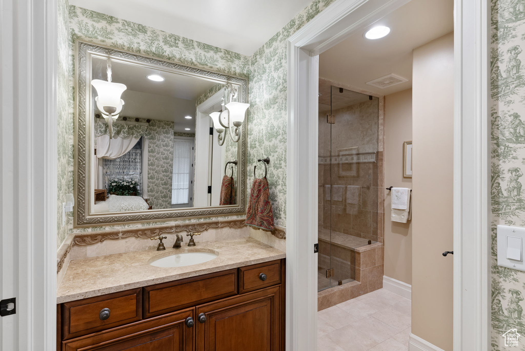 Bathroom with vanity, walk in shower, and tile flooring