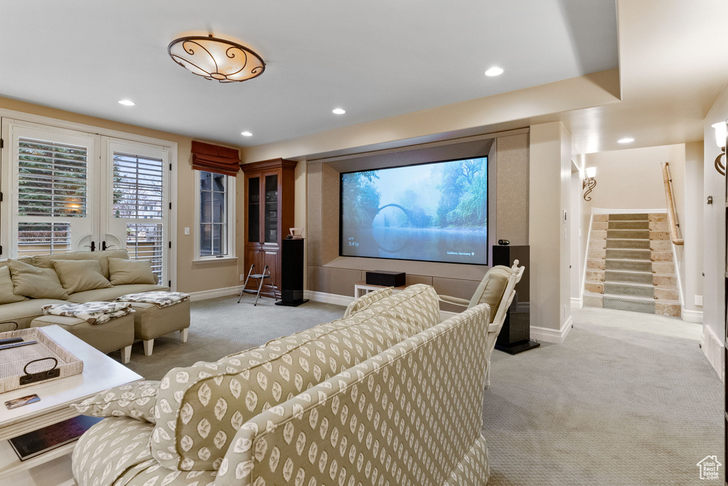 Home theater room with light colored carpet