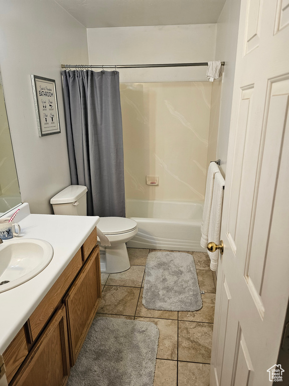 Full bathroom with vanity, toilet, shower / tub combo with curtain, and tile flooring