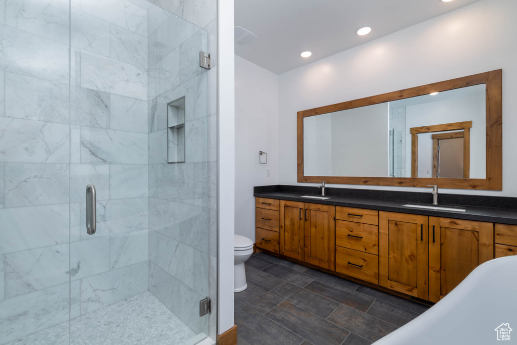 Full bathroom featuring dual vanity, tile flooring, separate shower and tub, and toilet