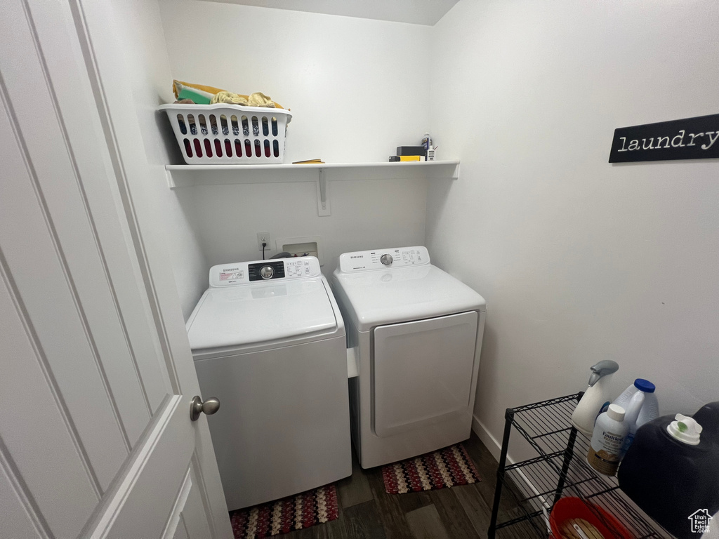 Laundry room featuring hookup for a washing machine, dark wood-type flooring, and washer and clothes dryer