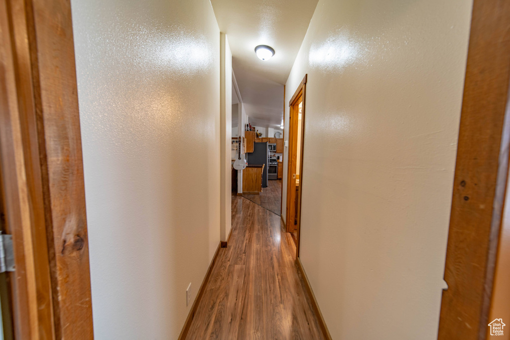 Hallway with hardwood / wood-style flooring
