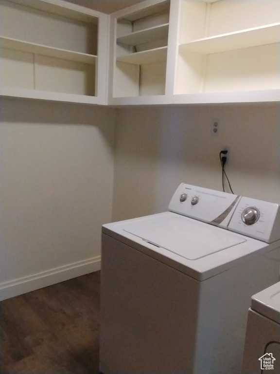 Laundry room featuring dark hardwood / wood-style flooring and washing machine and clothes dryer
