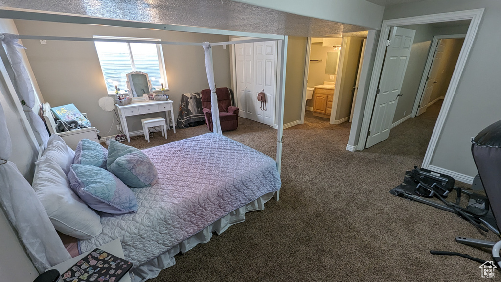 Carpeted bedroom featuring connected bathroom