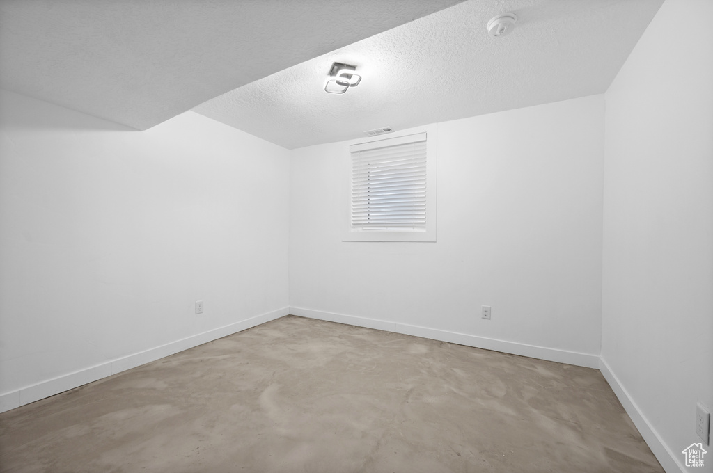 Unfurnished room with a textured ceiling