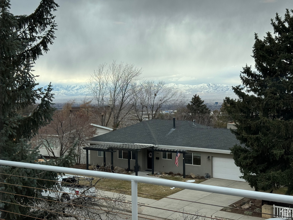 View of front of house featuring a mountain view and a garage