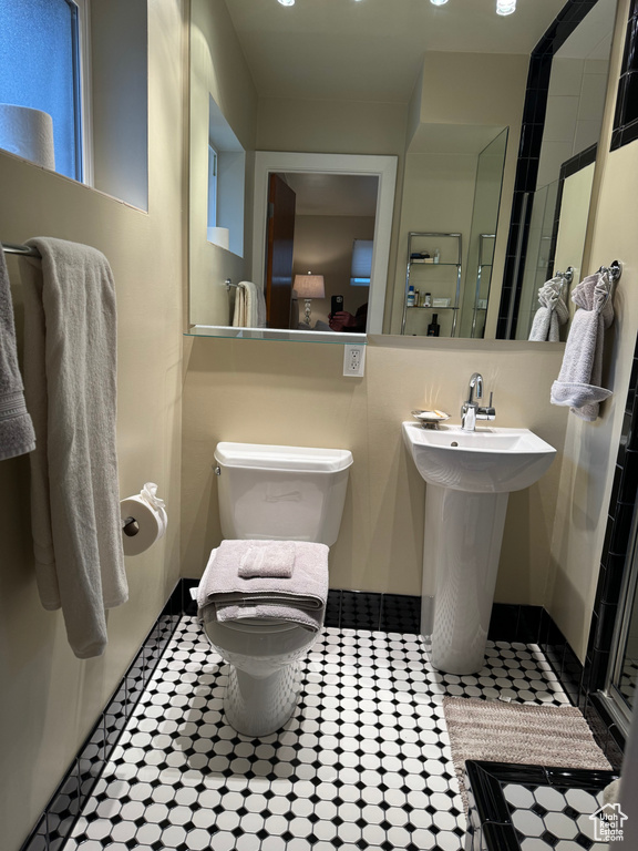 Bathroom with sink, tile floors, and toilet