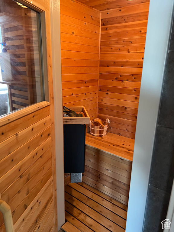 View of sauna featuring hardwood / wood-style flooring and wooden walls