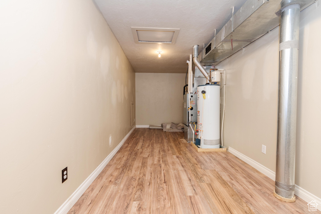 Basement featuring light hardwood / wood-style floors and gas water heater