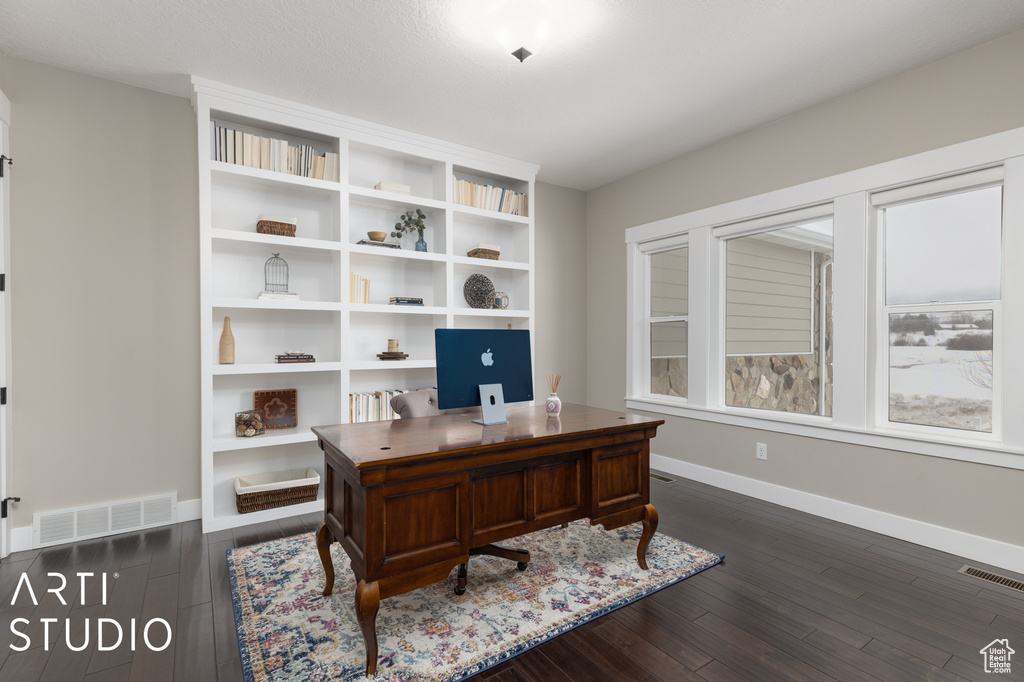 Office area with dark hardwood / wood-style floors