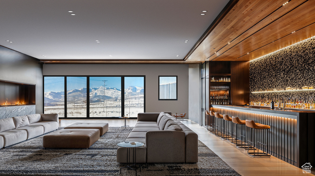 Living room with dark hardwood / wood-style flooring, bar area, and a mountain view