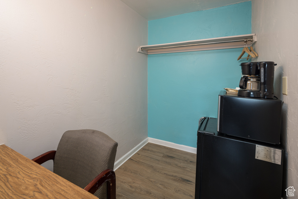 Office space with dark hardwood / wood-style floors