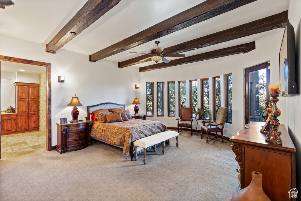 Tiled bedroom with ceiling fan and beam ceiling