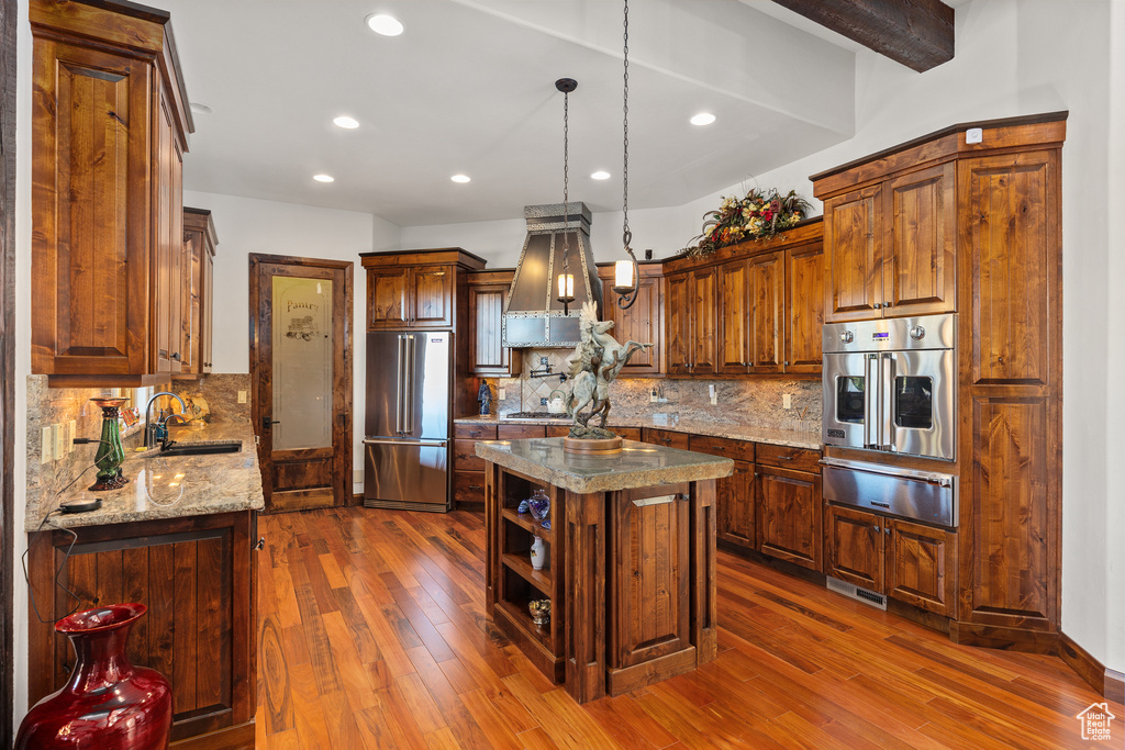 Kitchen featuring stainless steel appliances, a kitchen island, tasteful backsplash, sink, and dark hardwood / wood-style floors