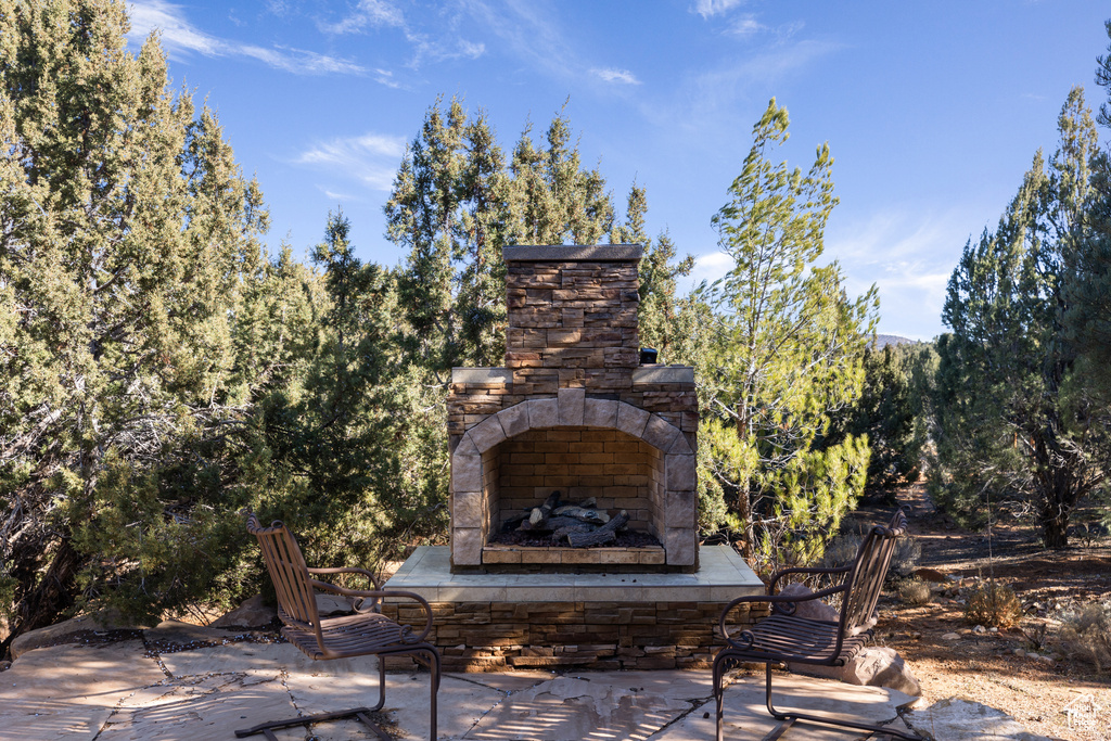 View of terrace with an outdoor stone fireplace