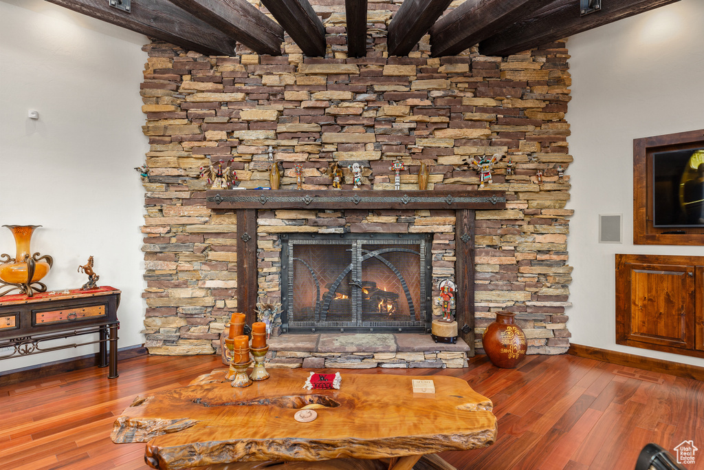 Details with dark hardwood / wood-style flooring, beamed ceiling, and a fireplace