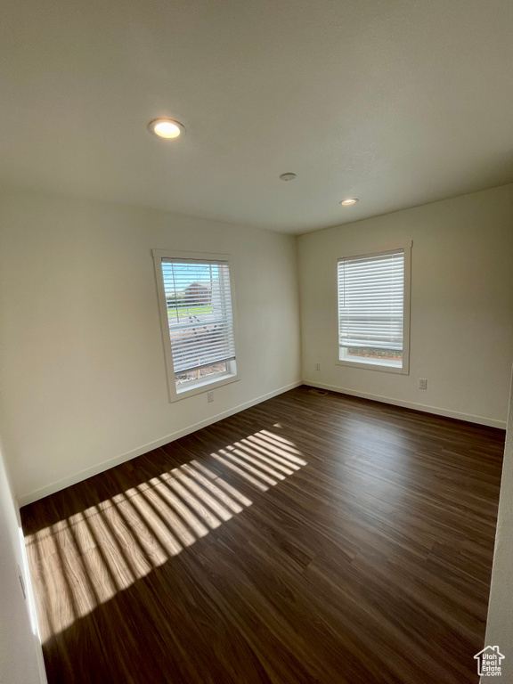 Unfurnished room with dark hardwood / wood-style flooring