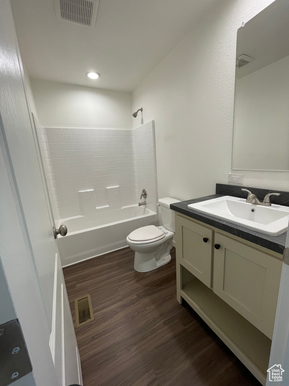 Full bathroom featuring shower / washtub combination, vanity, toilet, and wood-type flooring