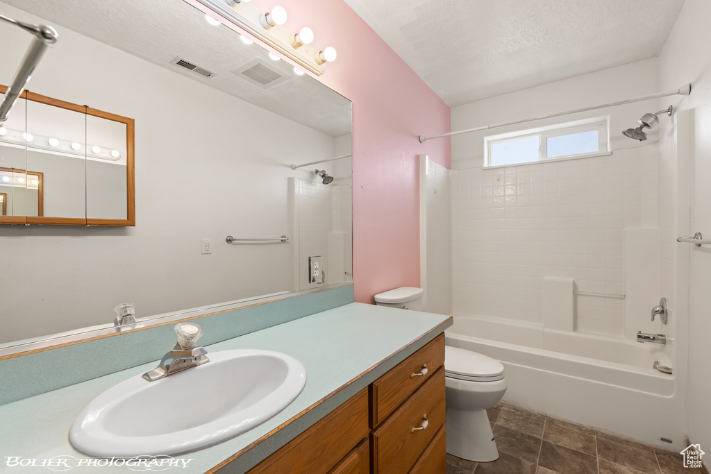 Full bathroom with shower / washtub combination, large vanity, tile floors, and toilet