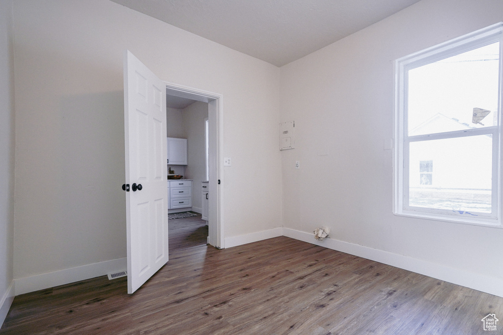 Unfurnished room featuring dark hardwood / wood-style flooring