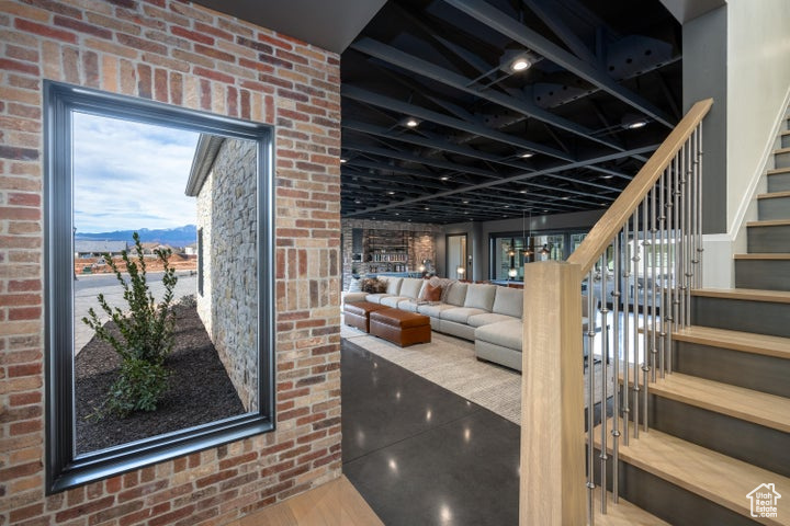 Interior space featuring brick wall and a mountain view