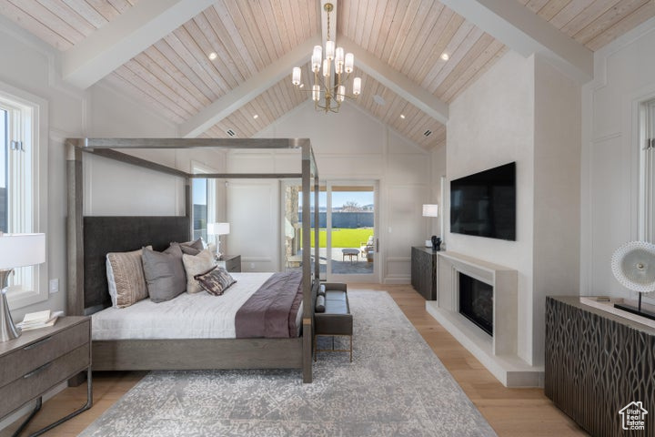 Bedroom featuring a notable chandelier, high vaulted ceiling, light hardwood / wood-style floors, beam ceiling, and wooden ceiling