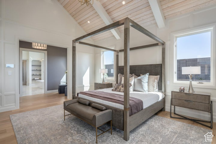 Bedroom featuring beamed ceiling, high vaulted ceiling, wooden ceiling, multiple windows, and light hardwood / wood-style flooring