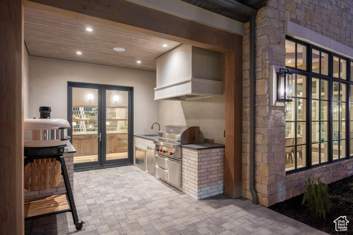 Interior space featuring a grill and an outdoor kitchen