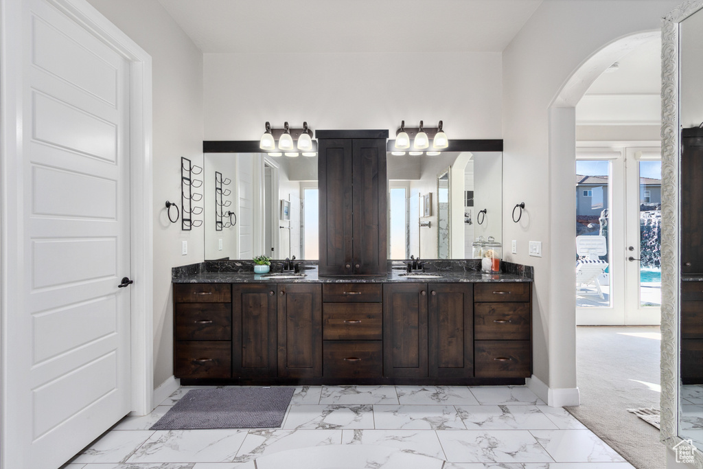 Bathroom with a wealth of natural light, tile floors, and vanity