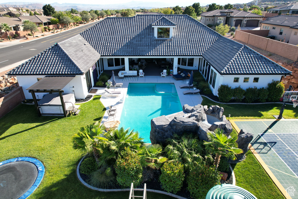 View of swimming pool featuring a patio and a yard