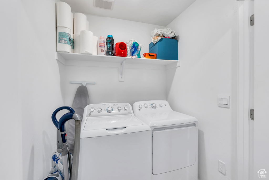 Laundry room featuring washer and clothes dryer