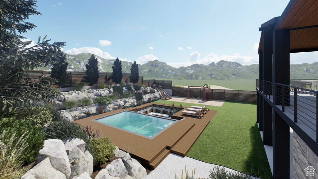 View of swimming pool with a yard and a mountain view