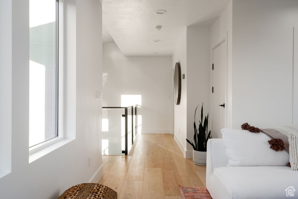 Hall with light hardwood / wood-style floors