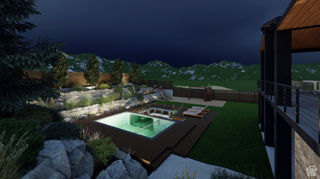 Pool at twilight featuring a yard and a mountain view