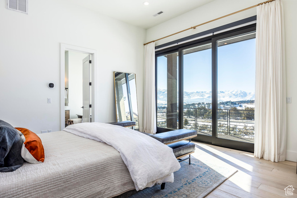 Bedroom featuring a mountain view and light hardwood / wood-style floors